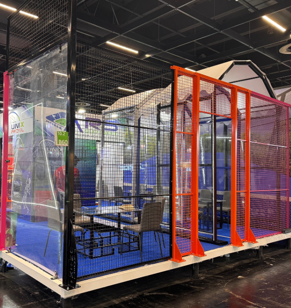Unix Padel team at the FSB Cologne trade fair stand in front of a panoramic padel court